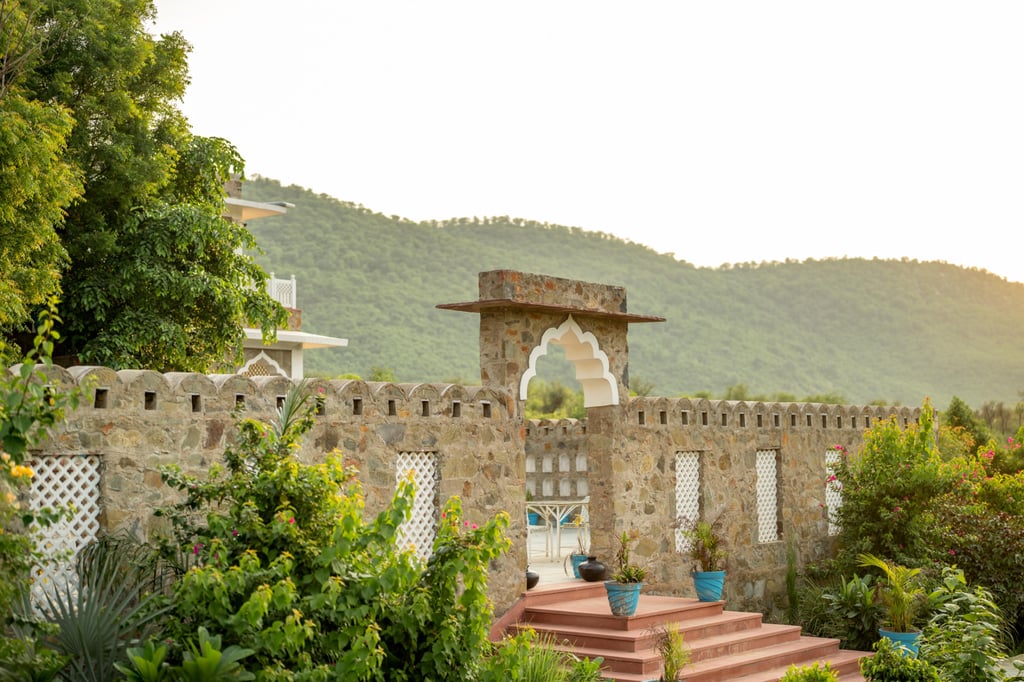 Stone architecture at Kutani Bagh against the Aravalli hills